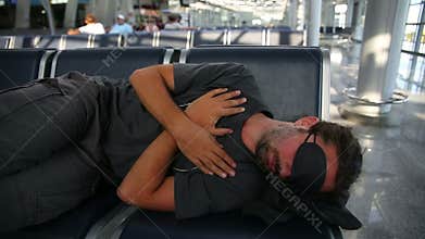 sleeping in airport with eye cover