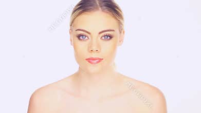 Beautiful woman blowing colourful particles