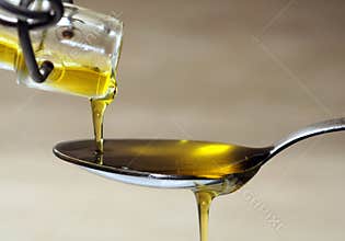 Olive oil over spoon