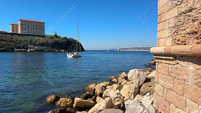 Rocky coastline with Palais du Pharo and sailboats in Marseille France
