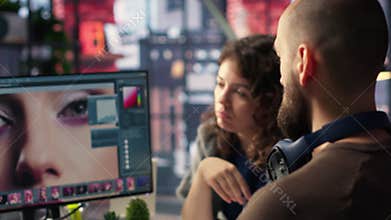 Graphic designer and photographer collaborate in a modern studio