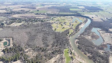 Aerial view over Kitchener, Ontario revealing farmland intersected by calm lakes and winding rivers