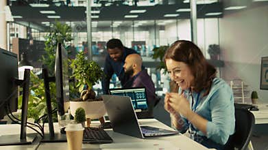 Accountant in busy modern startup agency imputing financial figures on PC