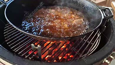 Cooking juicy meat over an open fire in the open air.
