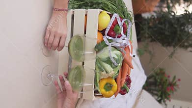 Women's hands take glass glasses with a healthy fresh drink made from green vegetables and fruits
