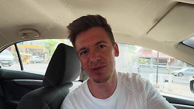 Man speaks about local traditions sitting on driver seat