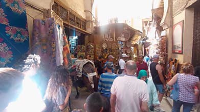 Tourists visiting Marrakesh old medina streets and traditional markets, Morocco