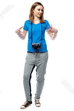 Happy animated young woman with a camera