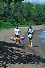 Two girls walking together along sandy beach path