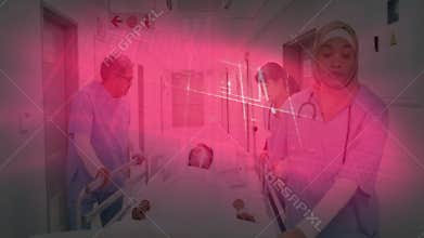 hijab-wearing nurse starting gurney push down corridor for transport while pausing for reassurance