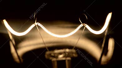 Shining light bulb in darkness