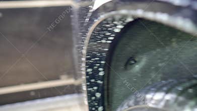 Close-up of interior cleaning in a car. A worker dirty car water blaster with a vacuum cleaner. Car dry cleaning.
