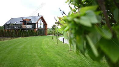 A Stunning Modern House with Expansive Green Lawn and Beautiful Landscaping