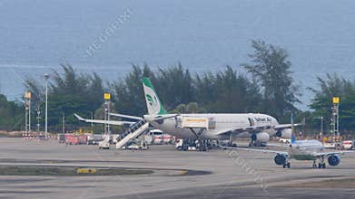 Uzbekistan Airways on airfield, sea behind