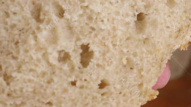 closeup of hand squeezing soft fresh bread crumb showing fluffy airy texture and