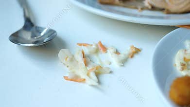 food spilled on a white table after a meal