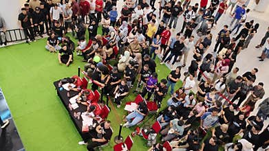 Large Group of People Attending an Indoor Event with Focused View