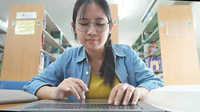 Young Woman Work On Laptop Computer Typing Point Of View At University Library