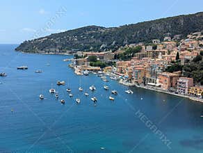 Beautiful summer view of the city of Villafranche in France with sailboats on the water