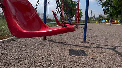 Empty swings swaying at playground