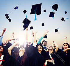 Cheerful Students Throwing Graduation Caps In The Air