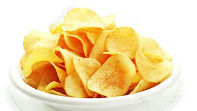 Potato chips heap rotating on a white plate