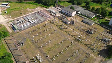 substation distributing electricity at forest. Magic aerial view flight drone