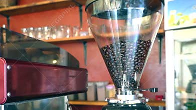 Close-up of whole coffee beans in a clear glass container