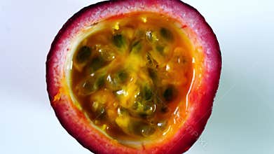Top view rotation of half passion fruit on white background.