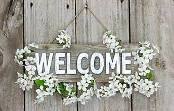 Welcome sign with pear tree blossoms