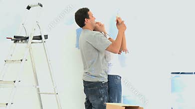 Woman having fun with her boyfriend during a renovation