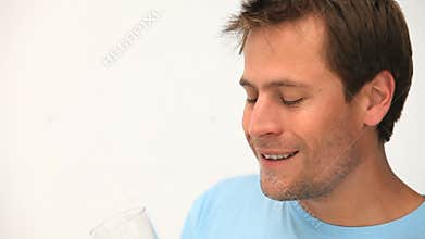 Man drinking a glass of orange juice