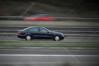 passenger car on the highway in motion with a blurred background