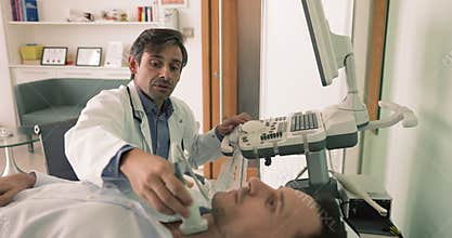 Endocrinologist check male patient thyroid gland using ultrasonography machine