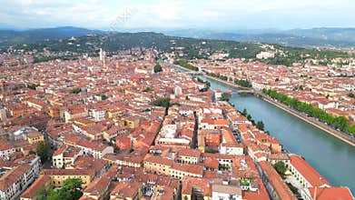 Drone view of Adige River along the city of Verona on a sunny day with cloudy sky in Veneto, Italy