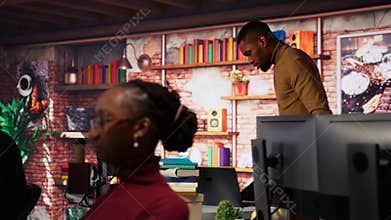 Man entering startup agency office holding laptop
