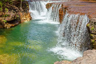 Waterfalls flowing into a narrow, pristine creek on Cape York, Australia.