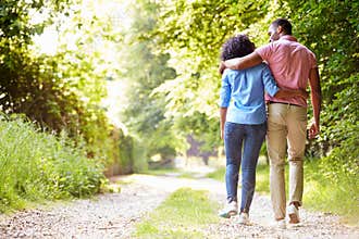 Young African American Couple Walking In Countryside