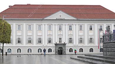 Walking in front of the city hall building (Magistrat der Landeshauptstadt) "Rathaus" on a rainy day