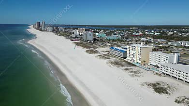 drone view of Gulf Shores beach with white sand, clear waters and the coastal city in the view