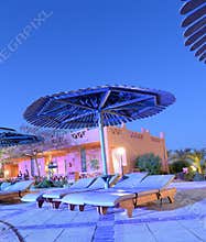 Poolside loungers at dusk