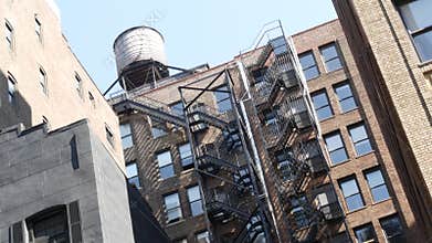 New York City building architecture. Residential house exterior. USA real estate. Rooftop water tower