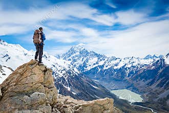Hiker at the top of a rock with backpack
