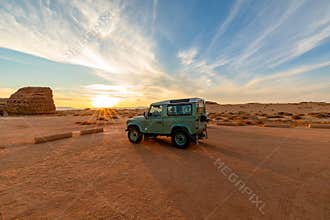 4x4 car parked near Qasr Al Farid in Hegra, Al Ula, Saudi Arabia, during sunset