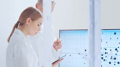 Scientific laboratory filled with various research equipment. Scientists are conducting experiments and research