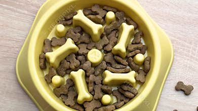 Dog food slowly disappearing from a slow feeder bowl