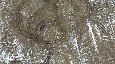 An aerial perspective showcasing unique tire track patterns on snowy terrain
