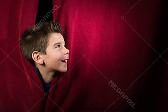 Child appearing beneath the curtain
