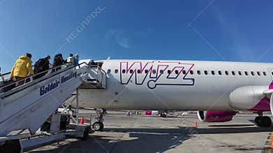 Passengers getting on the Wizz Air Airbus A321 Neo plane on a sunny day in Sofia city, Bulgaria
