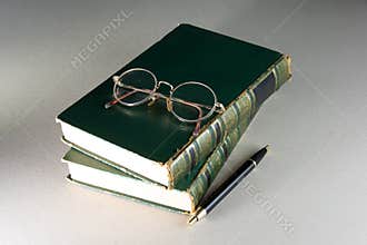 Vintage books stacked and glasses